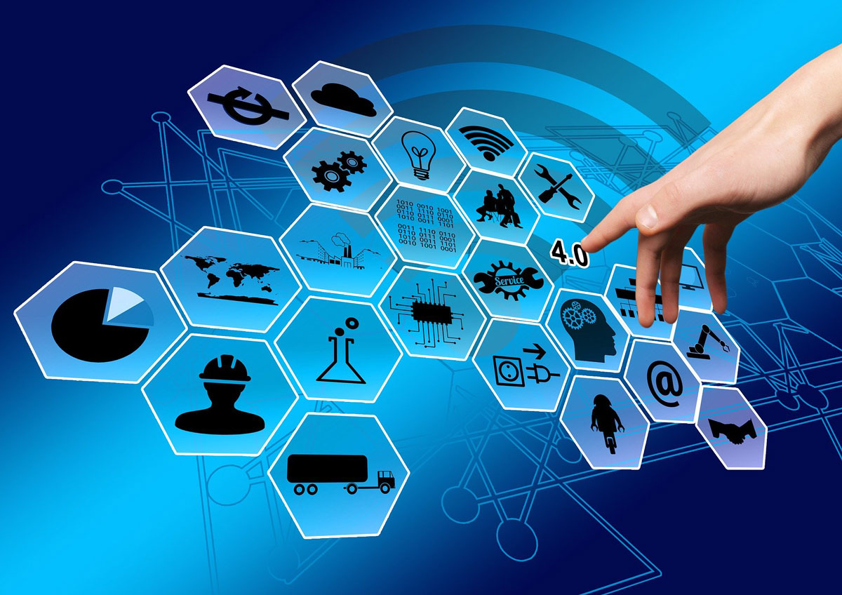 woman pointing towards icons related to IT/OT convergence and industry 4.0